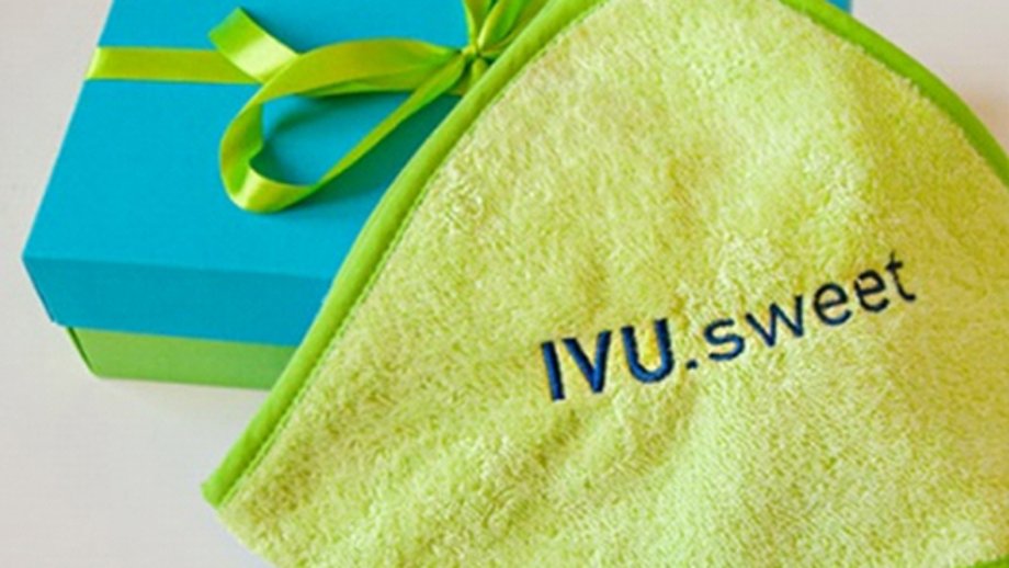 Small may green coloured handruch with the print IVU.sweet and a cyan and may green coloured package