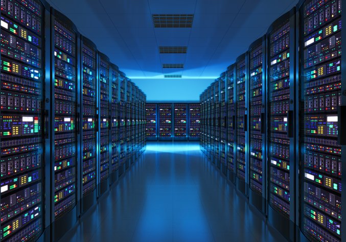 Server rows in blue-lit data centre with reflection on floor