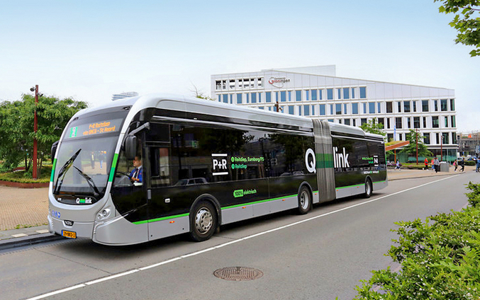 A bus from Qbuzz drives through a city