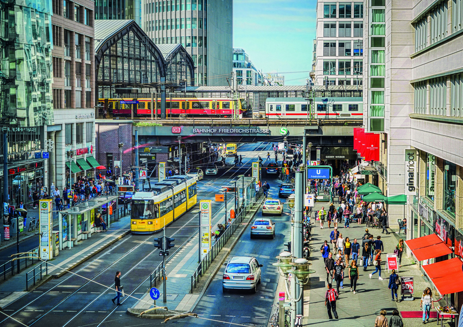Photo of the S-Bahn bridge Friedrichstraße in Berlin with moving trains and a tram below