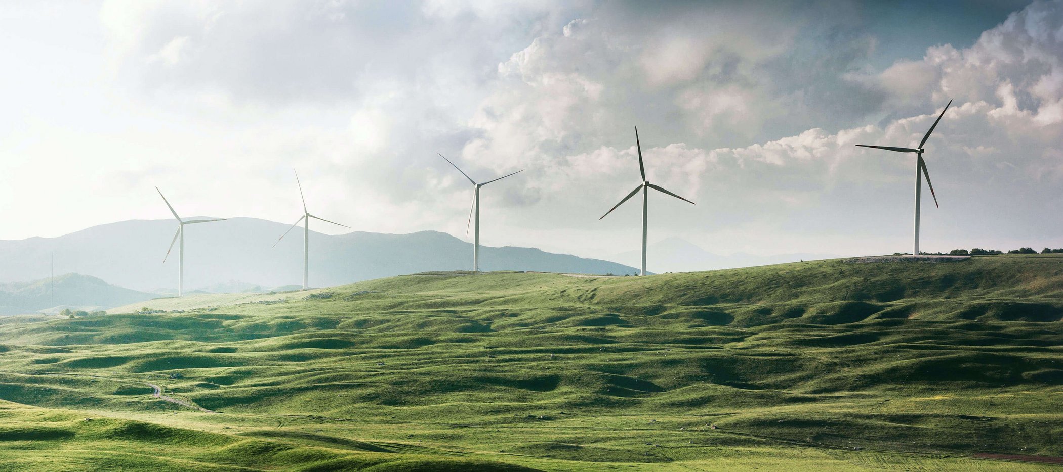 Wind turbines on green hills as a symbol of renewable energy and sustainability