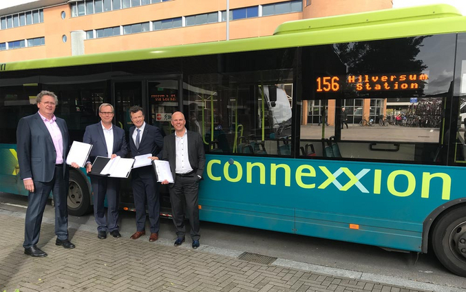 Four men in front of a Connexxion branded bus. From left to right: Andreas Hellwig, Division Manager Public Transport Operations at IVU, Matthias Rust, COO of  IVU, Bart Schmeink, CEO of Transdev Netherlands, Harry Wijers, COO of Connexxion