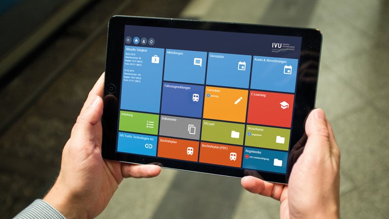 Person holding a tablet with a colorful tile-based interface