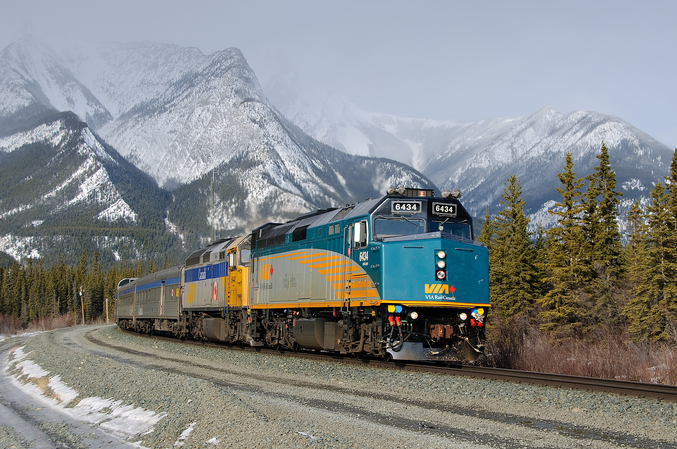 Via Rail railway in front of a snowy mountain landscape