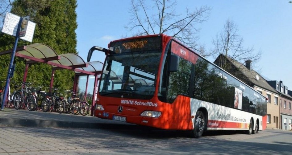 WVG bus at a bus stop with houses and bicycles in the background from a frog's-eye perspective