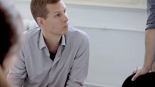 Man talking with his colleagues at a table