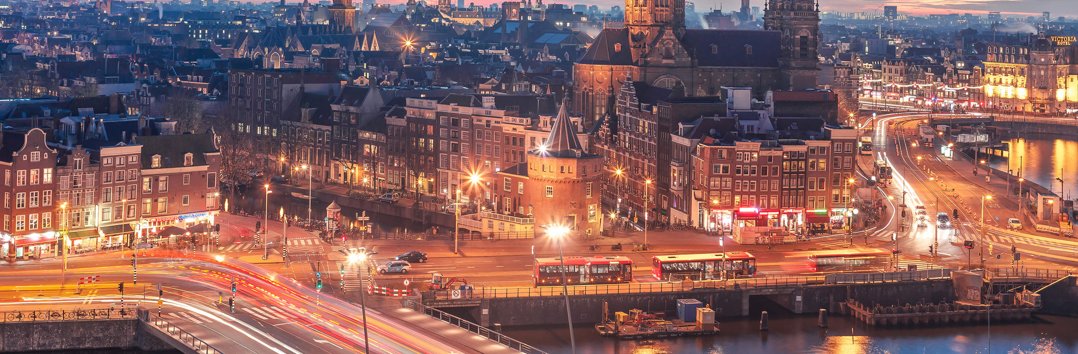 Amsterdam skyline at dusk with bright lights