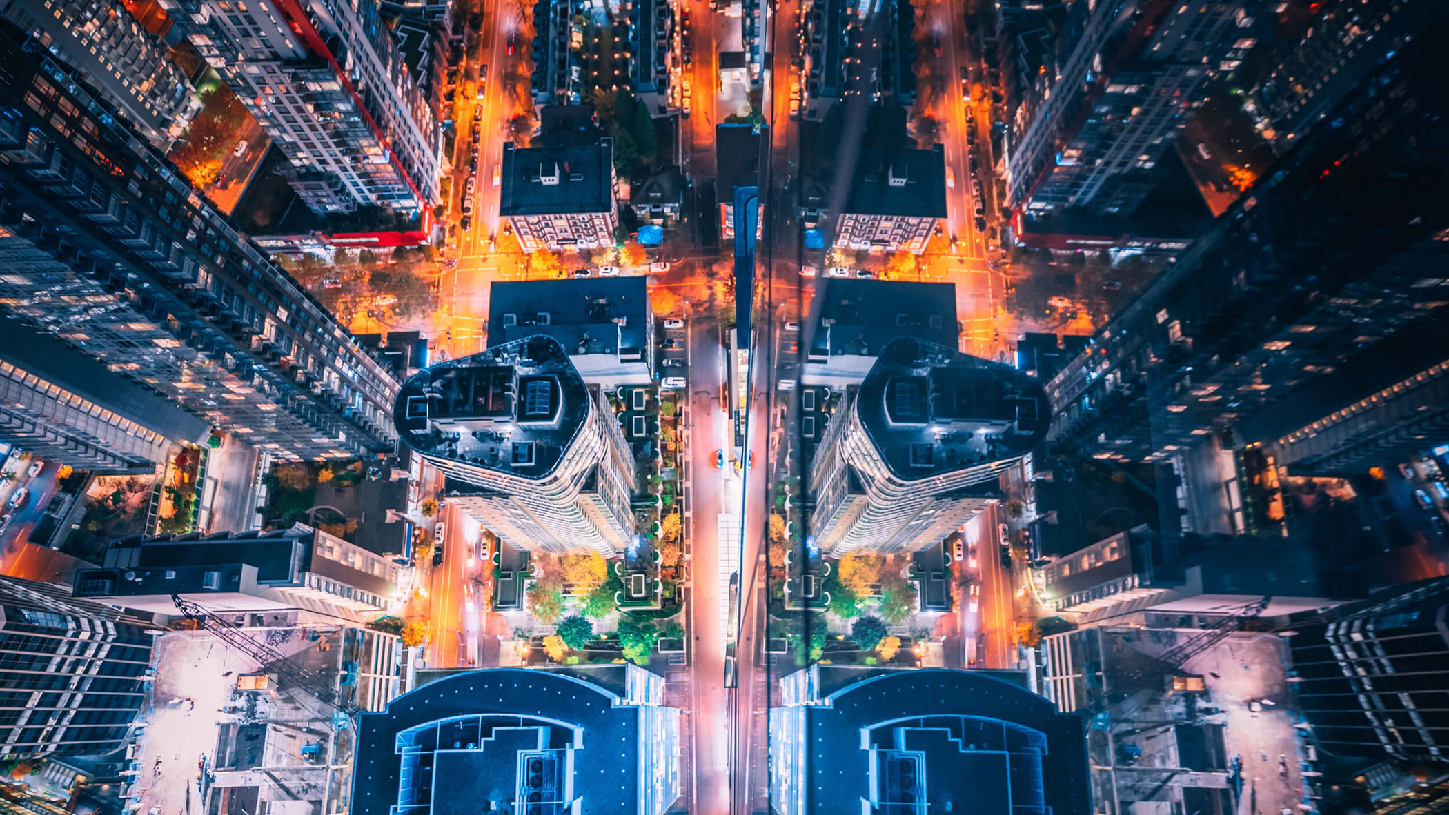 City at night vertically from above with bright lights of traffic