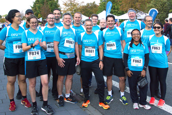 Group photo of the employees wearing the IVU cyan jerseys who took part in the company run.