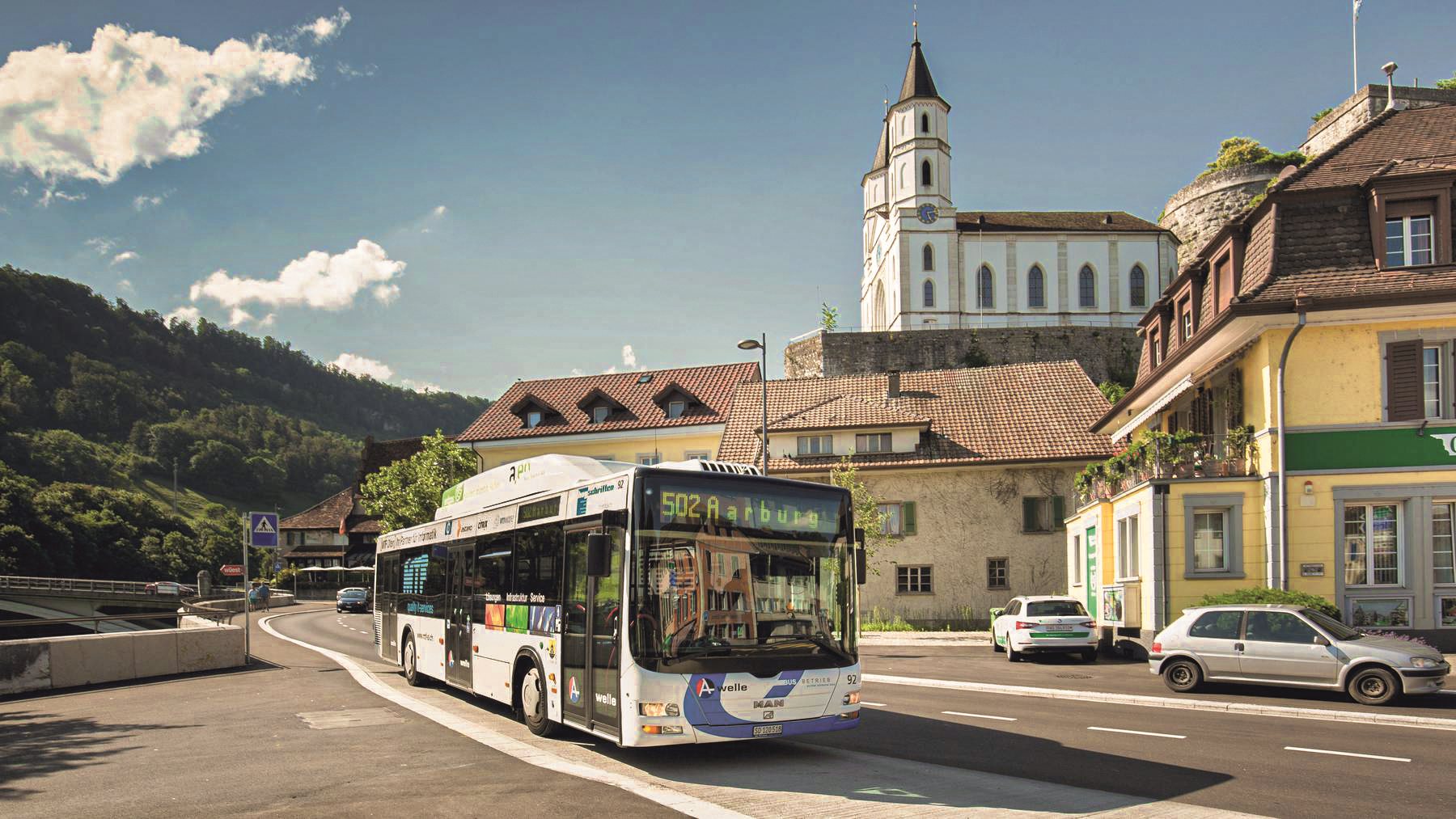 Line bus 502 to Aarburg driving through a Swiss town with a church in the background
