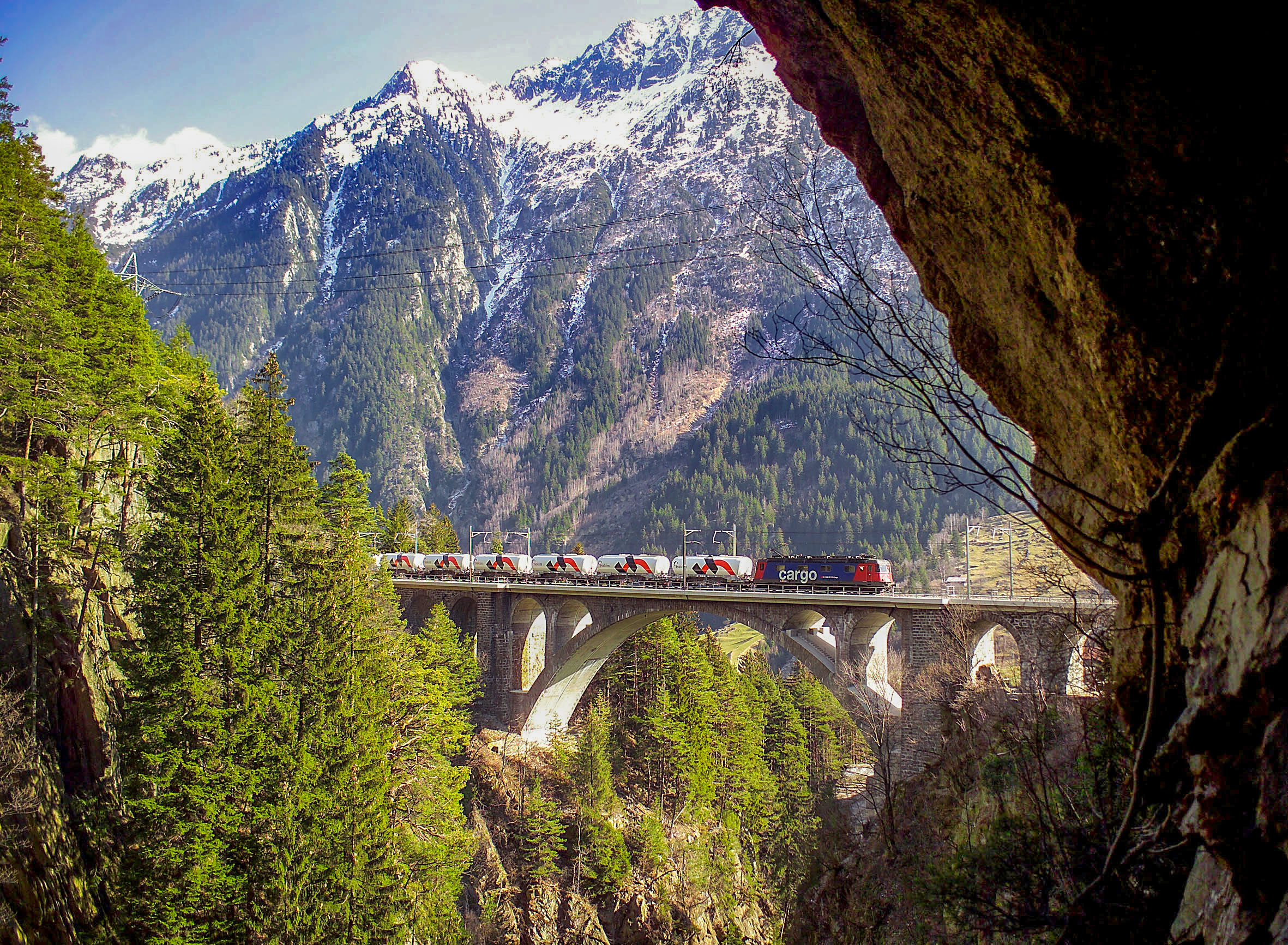 SBB Cargo train crossing a viaduct in the Alps