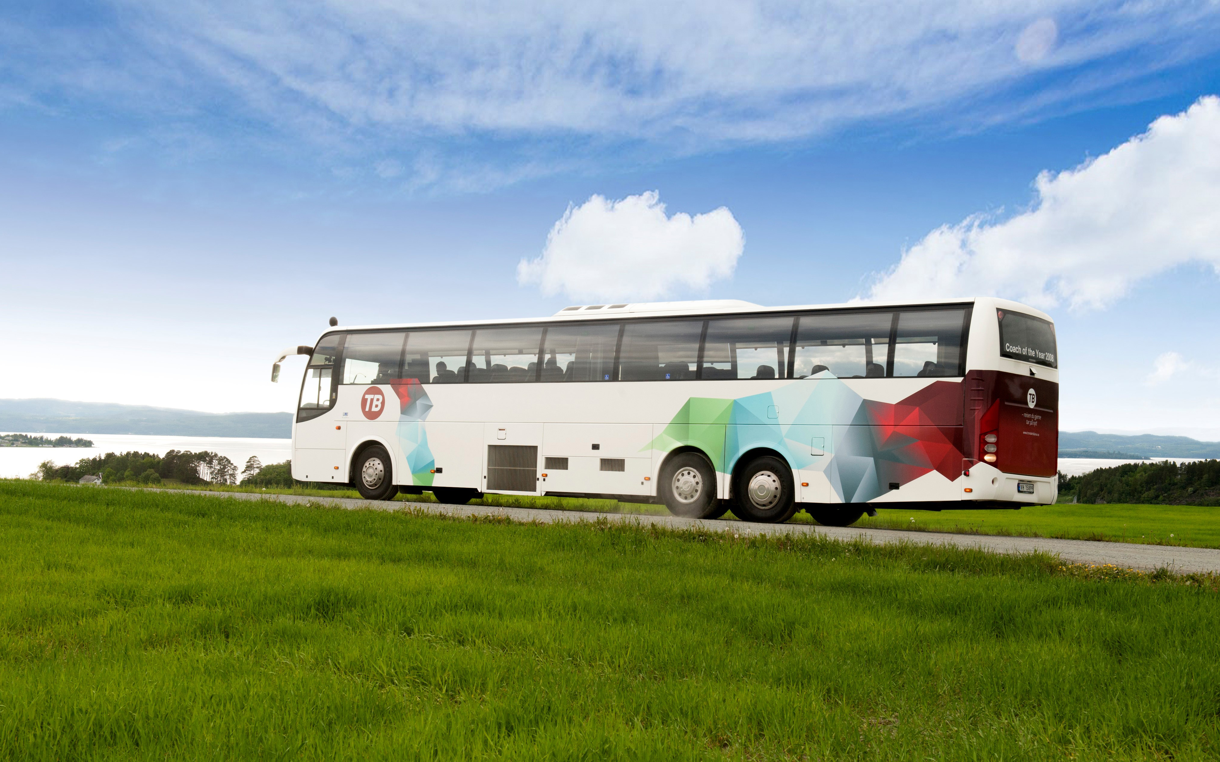 Torghatten bus between meadows by the water